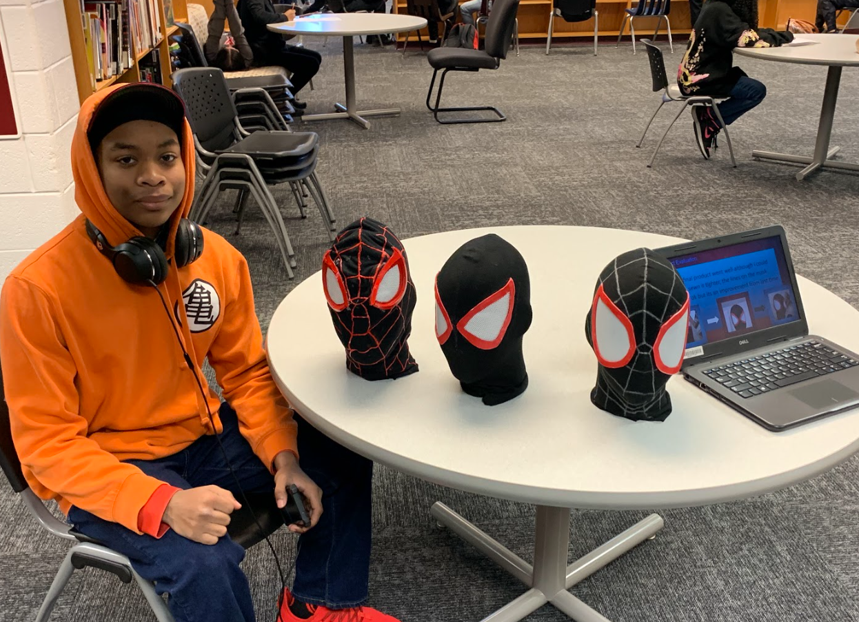 Image of student with hand sewn Spiderman masks.