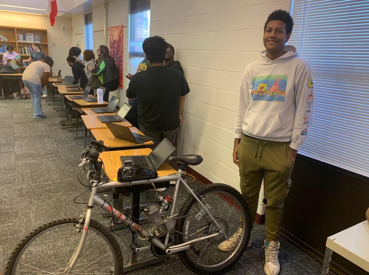 Image of student and his motorized bike